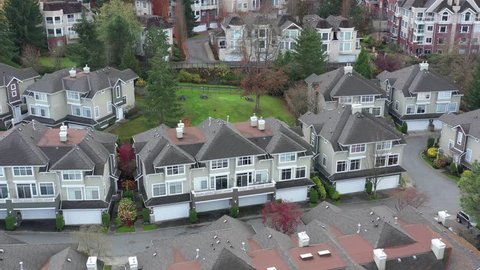 A perfect neighborhood. Houses in suburb at Summer in the north America. Luxury houses with nice landscape. Aerial drone view.