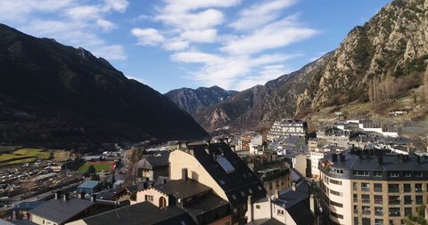 4k. Travel, drone view. Andorra. Europe. Sun shines over the summeries and blue sky. Little town between the mountains. Modern architecture