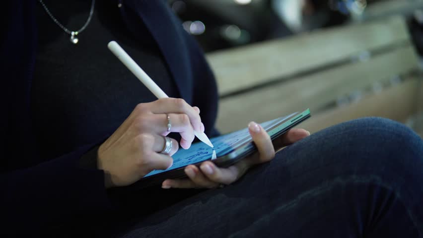 Slowmotion shot of a woman drawing on digital tablet with stylus pencil. Morern designer and paint artist. Royalty-Free Stock Footage #1019546548
