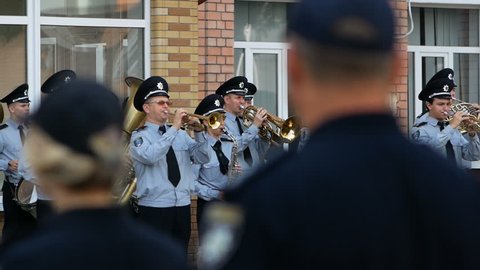 DNIPRO, UKRAINE- AUGUST 7, 2018: Musician military band of the Ukrainian national police plays the trumpet on the march on parade for 3d national championship of canine national polices in the