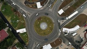 This stock video shows a top view of a roundabout on a busy morning. Vehicles fill the roundabout as they drive to get to work. Use this clip for TV and movie sequences, news features, traffic reports