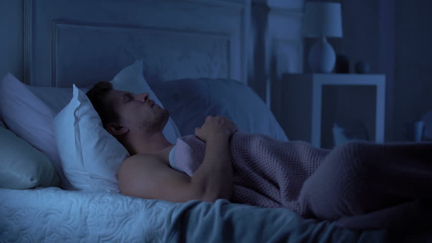 Young male sleeping unwell, suffering nightmare talking in sleep, troubles | Shutterstock HD Video #1019571091