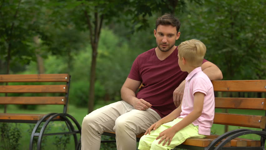Conversation between father and son in park, loving dad giving advices to kid