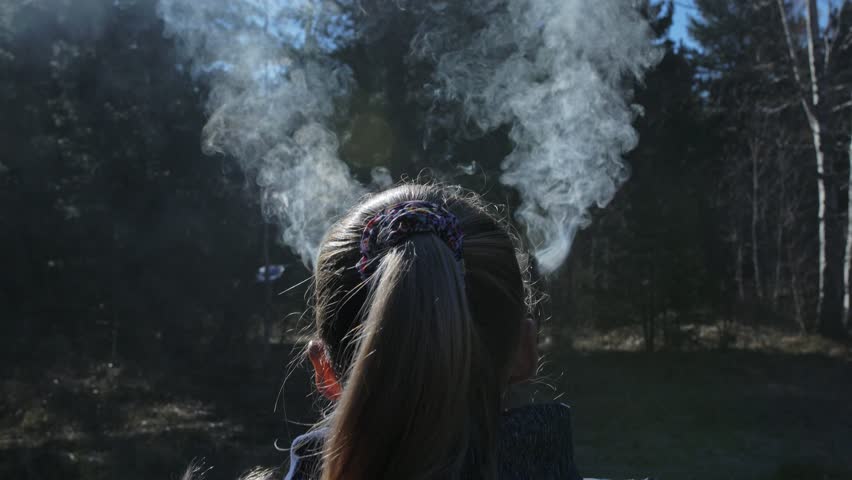 The woman has smoke coming out of her head and ears. Behind the girl is a ritual pot ashtray for outdoors ceremonies.
