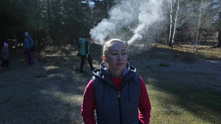 The woman has smoke coming out of her head and ears. Behind the girl is a ritual pot ashtray for outdoors ceremonies.