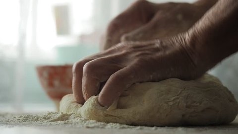 80 Years Old Woman Hands Kneading Dough. Grandmother Kneading Dough In Flour On Table, Slow Motion. Wheat Homemade Bread. Hands Of Granny  Kneads Dough. Pastry And Cookery