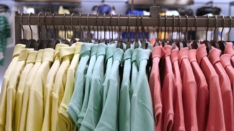 Colorful Polo T-Shirts Displayed On Hangers At Clothing Store. Close-Up.
