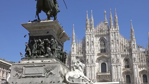 The Milan Cathedral (Duomo di Milano) and monument to Victor Emanuel II in the Piazza del Duomo in Milan, Italy, slider dolly shot 4k