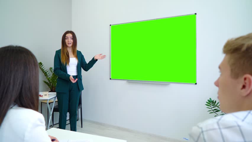 young happy teacher near with a green screen board teaching students in classroom. interactive education, practice, learning, education, knowledge concept Royalty-Free Stock Footage #1019589100
