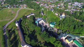 Over the Svyato-Uspensky Pskovo-Pechersky monastery on a Sunny June morning (aerial video). Pechora, Russia