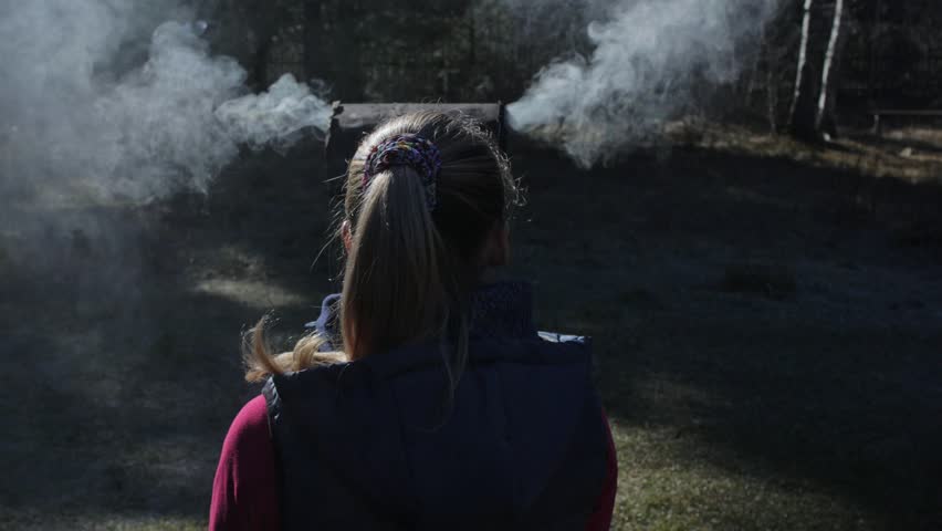 The woman has smoke coming out of her head and ears. Behind the girl is a ritual pot ashtray for outdoors ceremonies.