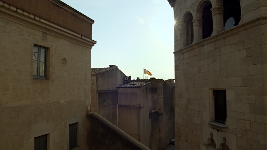Old Town environment and Catalan Flag. Beautiful Flare. Catalonia. Spain.
