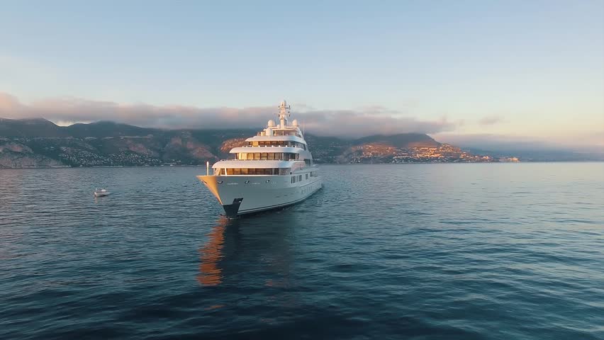 Front view of large super yacht and small boat underway. Luxury super yacht. Royalty-Free Stock Footage #1019616751