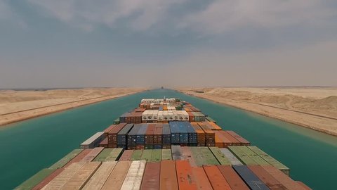 Suez, Egypt - huge container vessel proceeding through the Suez Canal. Time laps