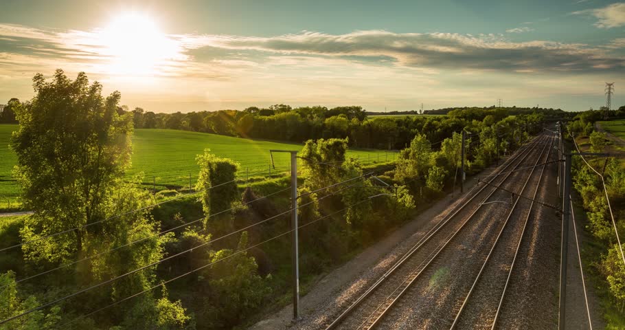 High speed passenger train in motion on railroad at sunset