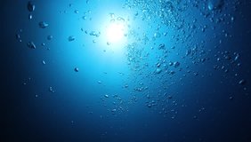 Underwater air bubbles in blue ocean 