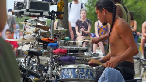 GERMANY - CIRCA JUNE 2017 - Exotic drummer plays music drum set, busker performance, Mauer Park, Berlin