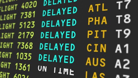 A close up view of an airport's travel information board with flights being delayed, possibily due to bad weather conditions.  	