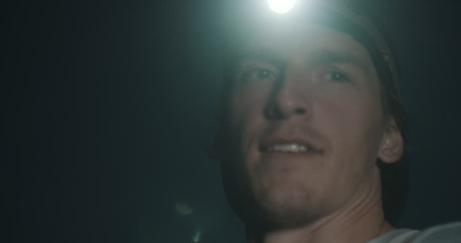 Trail runner with head light tired catching breath