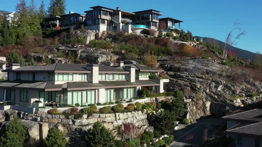 Houses in suburb at Fall in the north America. Luxury houses with fantastic mountain view. Aerial drone view.