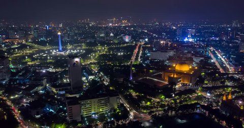 JAKARTA, Indonesia - November 15, 2018: Beautiful aerial time lapse/hyperlapse of Jakarta downtown at night with view of National Monument (Monas) at night. Shot in 4k resolution
