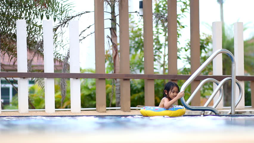 Young asian women feel relaxing at swimming pool
