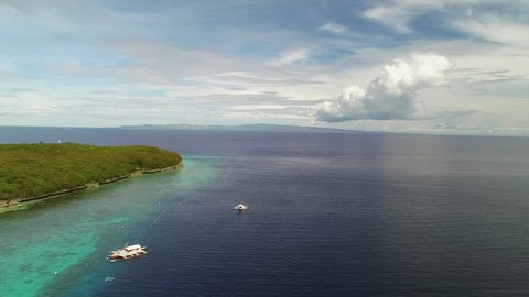 Aerial view of Sumilon Island and outrigger boats, Philippines.
