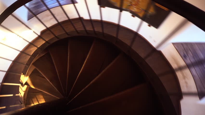 Spiral staircase. Spiral staircase. Sun glare on the railing. Royalty-Free Stock Footage #1019650543