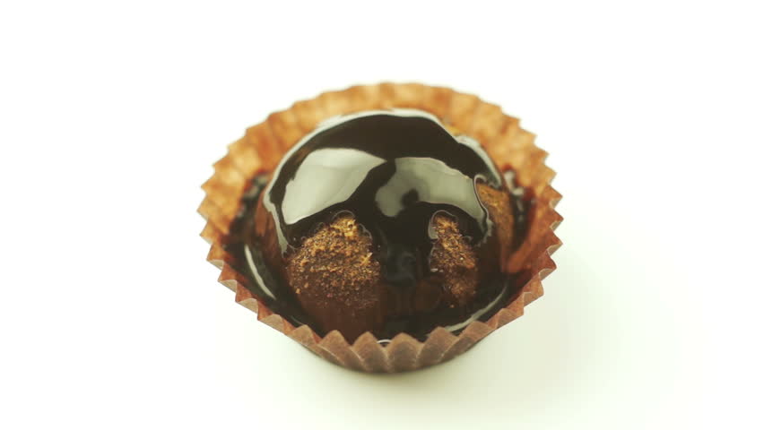 Spoon breaks cake poured chocolate syrup