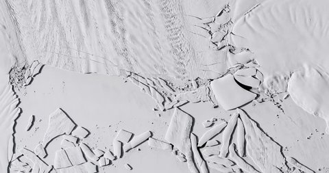 Very high-altitude overflight aerial of iceberg calving, Pine Island Glacier, Antarctica. Clip loops and is reversible. Elements of this image furnished by NASA