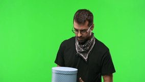 Man with glasses on green screen chroma key background holding a gift