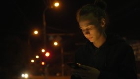 calm handsome young boy on the street in the city, night traffic, 4k