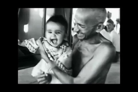 Bombay, India. About 1931 . Mahatma Gandhi hugs a small child