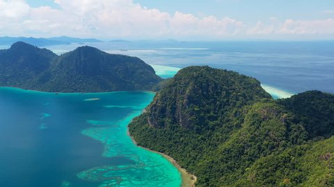 Aerial panoramic view of Pulau Bodgaya / Bohey Dulang Islands, turquoise crystal clear waters, beautiful lagoons and coral reefs of Celebes Sea - landscape panorama of Borneo, Malaysia, Pacific Ocean