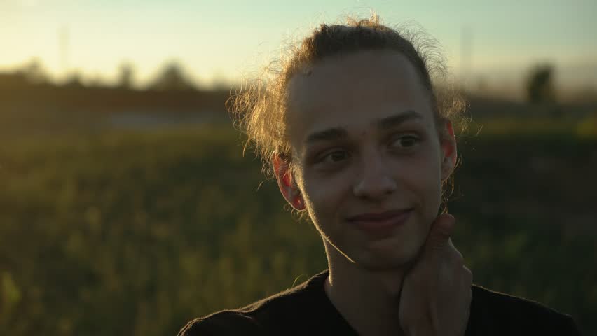 portrait of cute guy oudoors on the natural bg, close up,4k