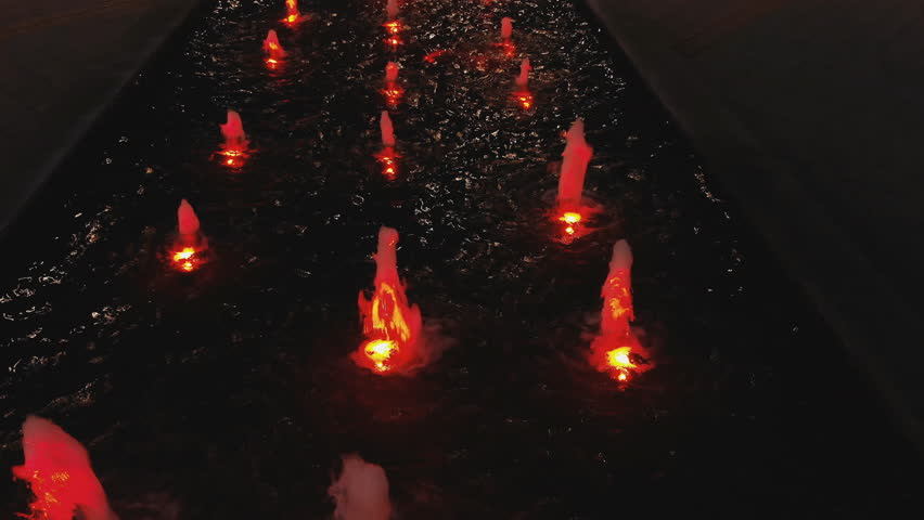 Night water fountain aerial above drone view