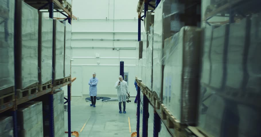 Workers in modern warehouse check the process of transportation. Royalty-Free Stock Footage #1019692300