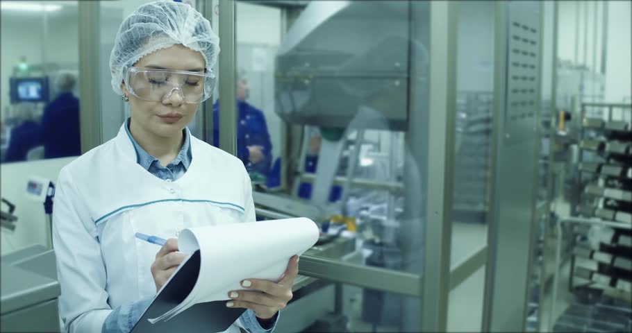 Pharmaceutical Factory Worker. Worker Using Control Panel.A female technician is monitoring the process. Royalty-Free Stock Footage #1019692324