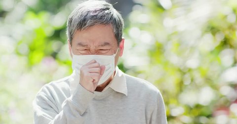old man wear mask and cough outdoor