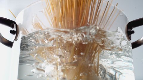 Camera follows cooking spaghetti noodles in boiling water. Shot with high speed camera, phantom flex 4K. Slow Motion.