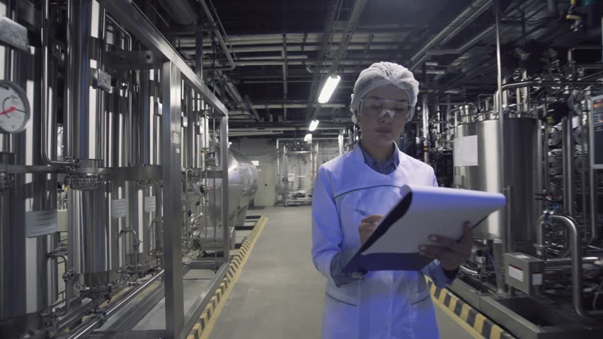 Engineer woman in industry factory checking production. Royalty-Free Stock Footage #1019706307