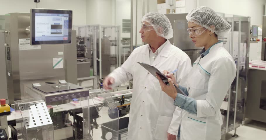 Two medecine factory engineers discussing working process, Royalty-Free Stock Footage #1019706367