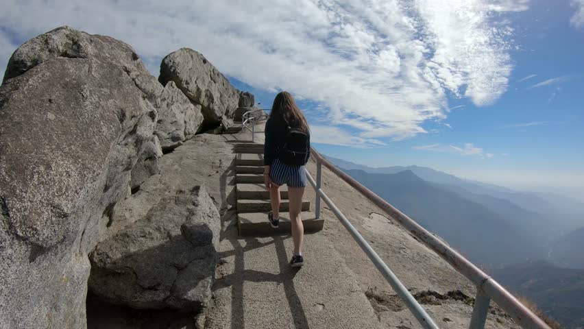A girl climbing the Moro Rock in Sequoia National Park, California, USA