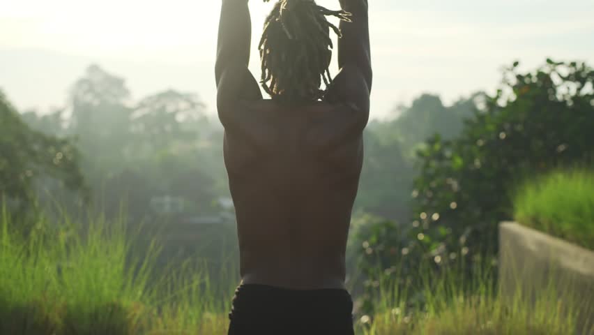 Black afro man do bikram yoga at roof top with solar battery rapid slow motion
