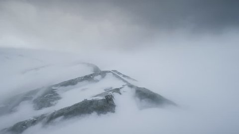 Blizzard Over Antarctica Mountains. Aerial Time Lapse Over South Pole. Harsh Wild Environment. Natural Polar Phenomena in Antarctic Midsummer. Winter Landscape In Grey White Tints. 4k Footage.