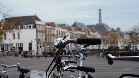A close up of a bycicle with the city centre of Leiden blurred at the background on a autumn day in the netherlands