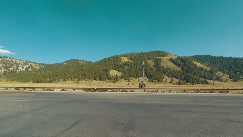 Driving in Grand Teton, Wyoming turning at Intersection, Point of View - Mounted 2.7k Ultra HD footage