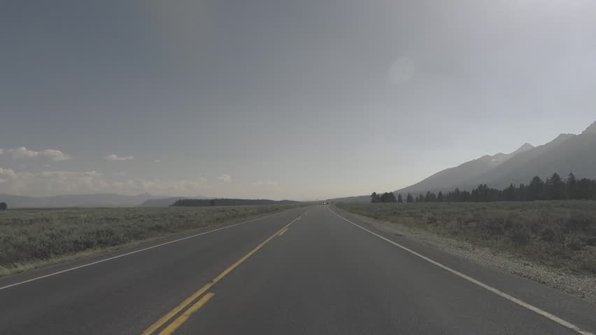 Driving a Car through Grand Teton park, back light, Point of View - Mounted 2.7k Ultra HD footage