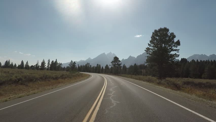 Driving a Car in Grand Teton park fast-forwarded, sunny, Point of View - Mounted 2.7k Ultra HD footage, No Filter
