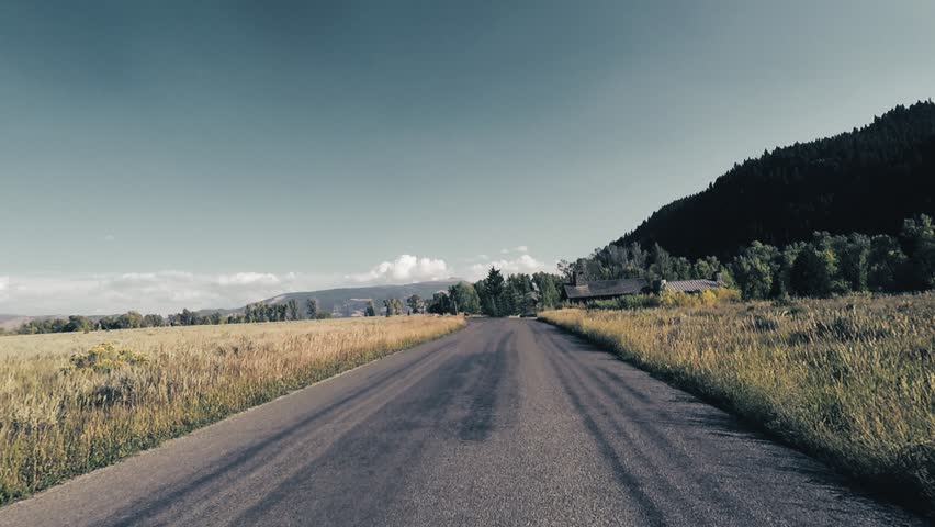 Driving in Grand Teton, Wyoming turning at Intersection, Point of View - Mounted 2.7k Ultra HD footage
